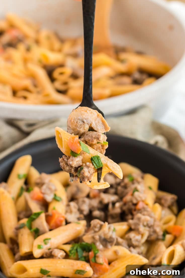 Skillet of pasta and ground beef.