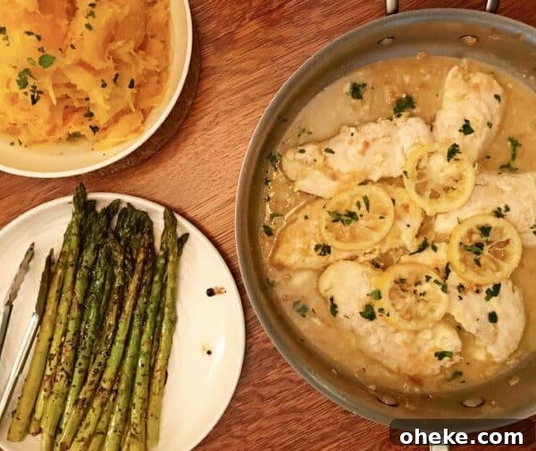 Saute pan holding sauced chicken with lemon, plates of asparagus and squash