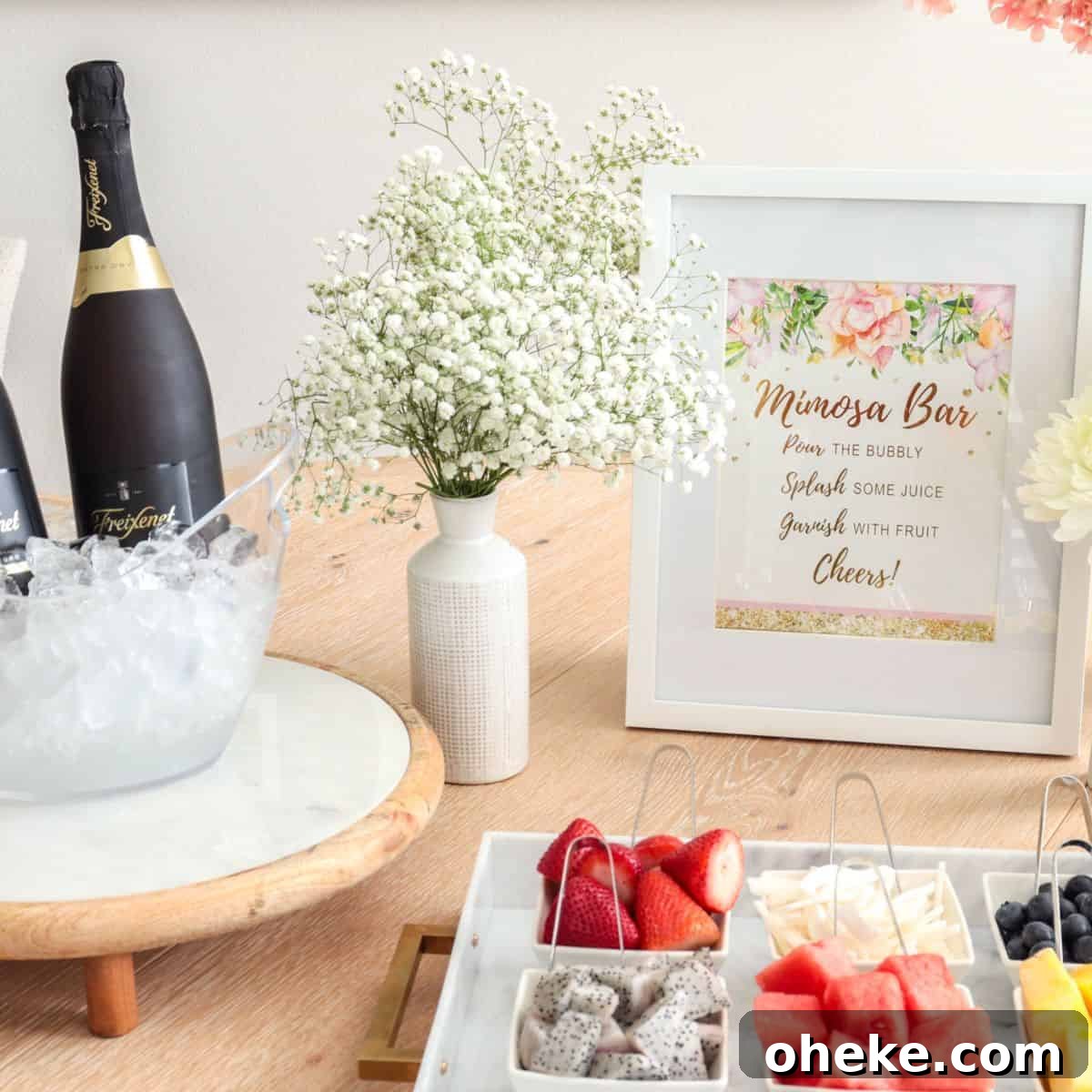 Build a Bloody Mary Bar: DIY Cocktail Station Guide 13 Mimosa bar table set up with fruit and champagne and sign.