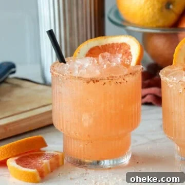 Blood orange margarita with orange slice.