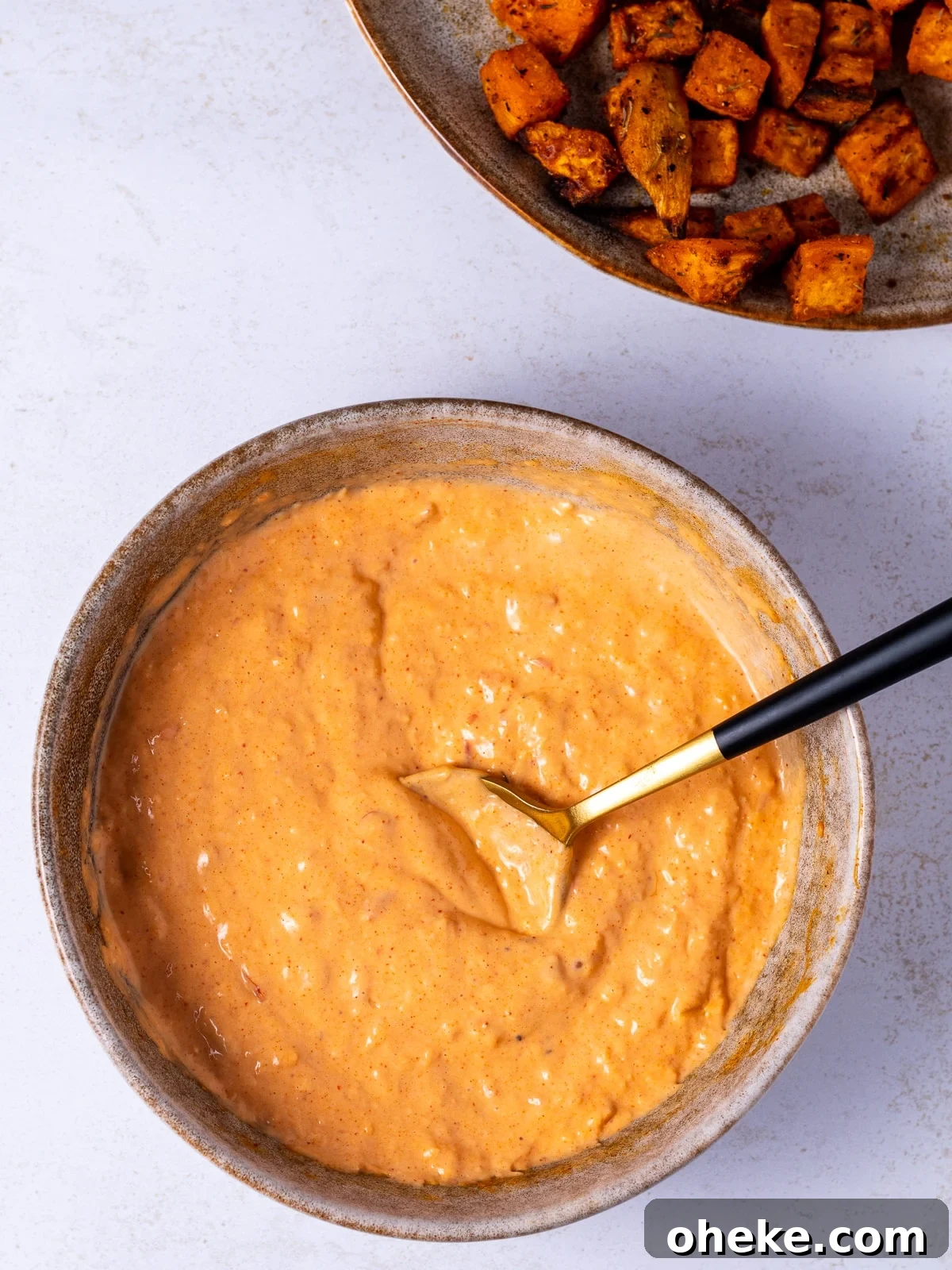 bowl with harissa aioli and a spoon