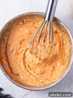 bowl with harissa aioli and a whisk