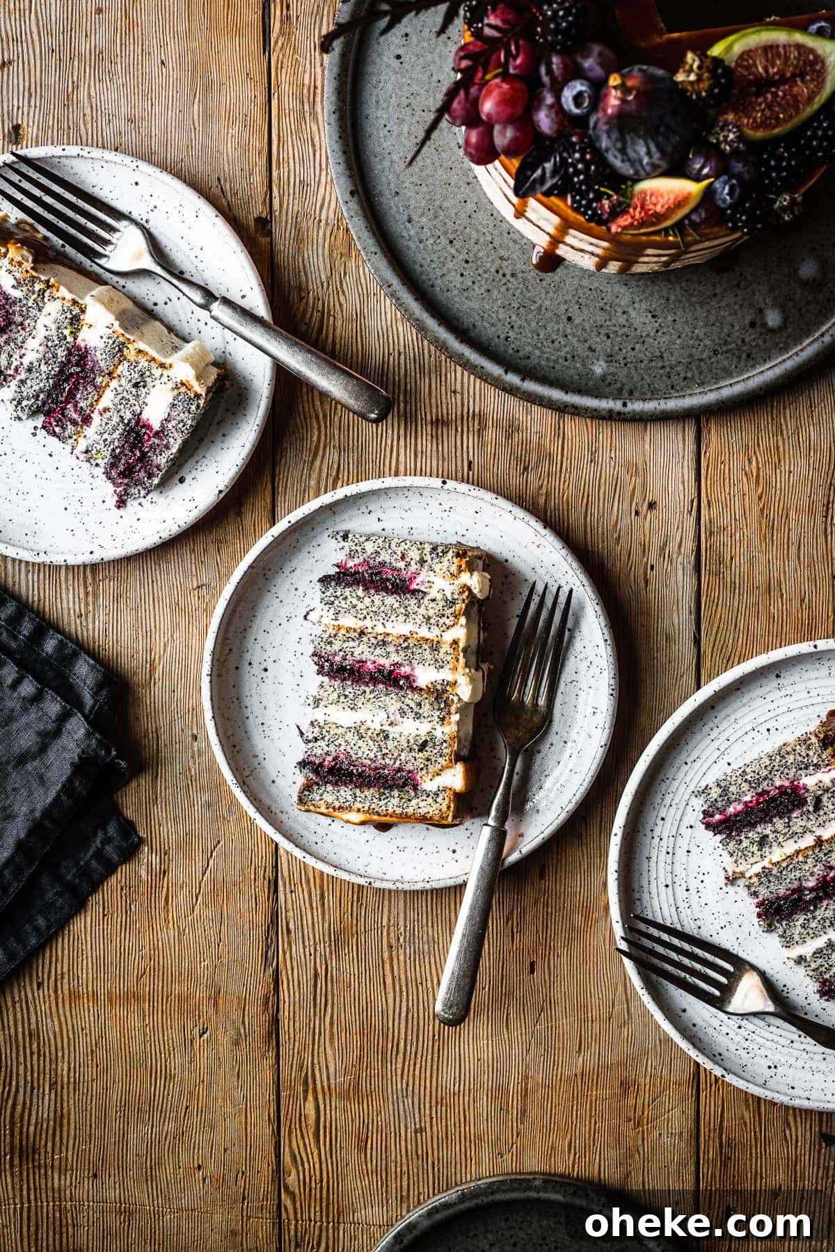 Blackberry Poppy Seed Bundt Cake with Lemon Glaze 6 Three slices of blackberry poppy seed cake on white ceramic plates.