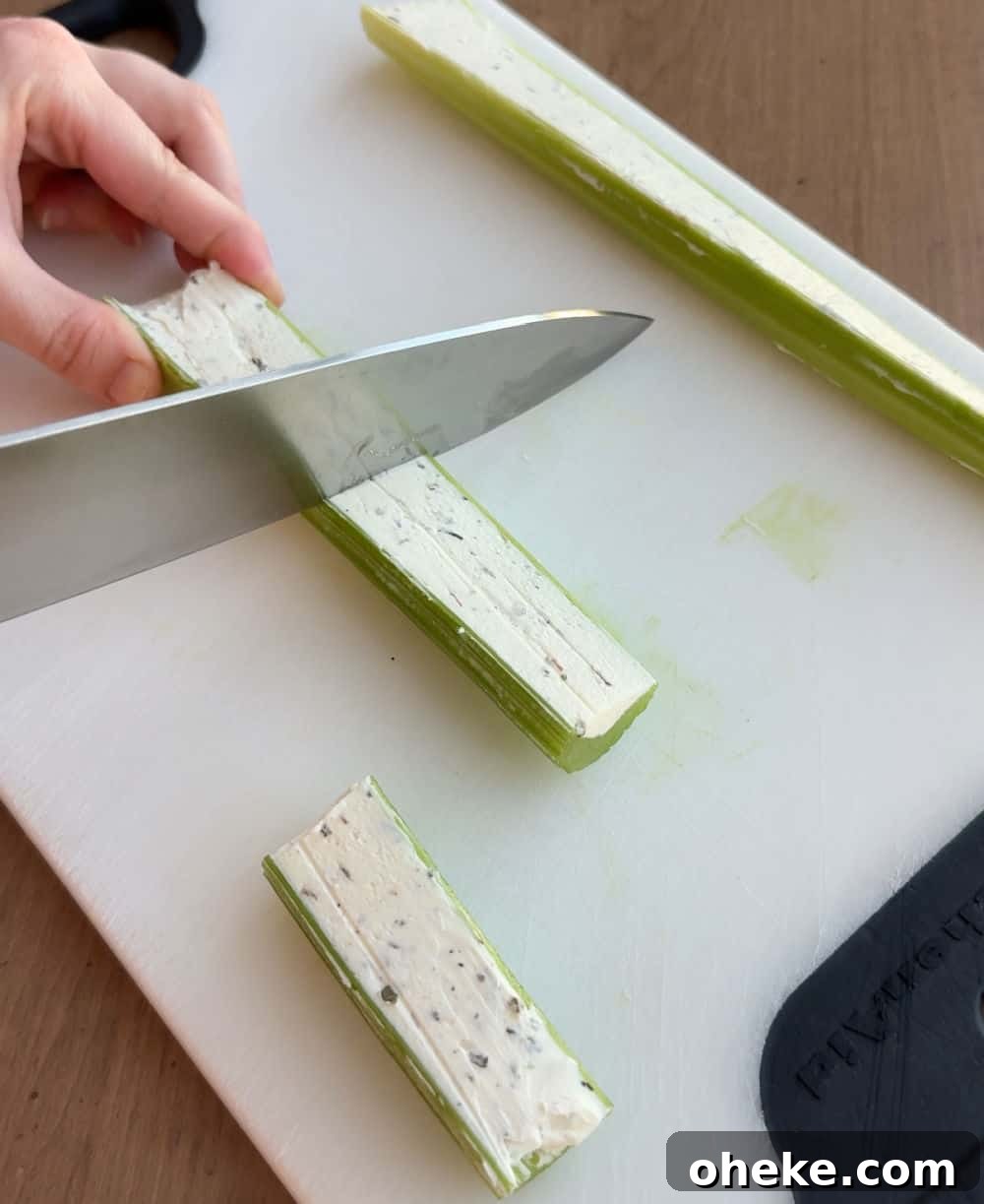 Mom’s Classic Stuffed Celery Recipe — Party Appetizer 7 slice stuffed celery with knife.