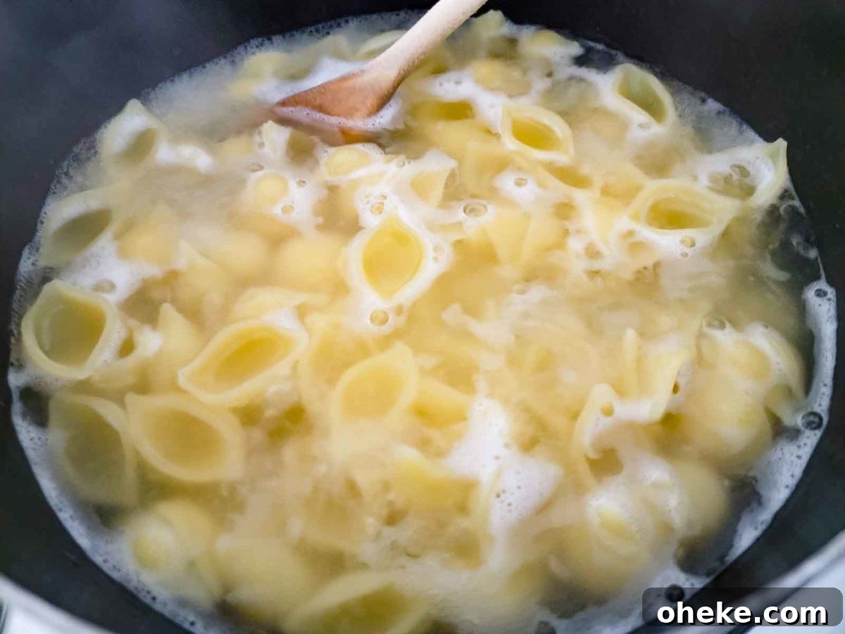 shell pasta cooking in a pan.