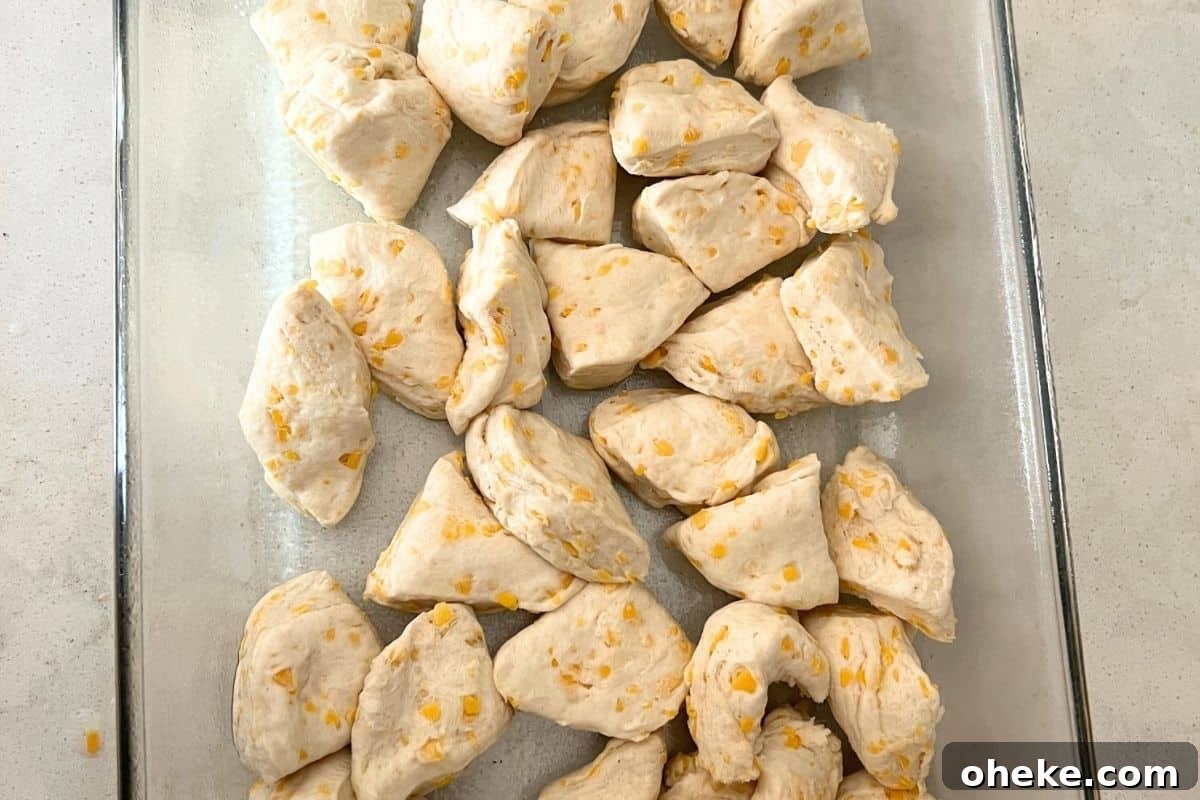 Bubble-Up Pizza: Quick Sheet-Pan Pizza Casserole Recipe 4 Quartered biscuits in bottom of casserole dish.