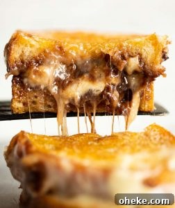 Nutella Grilled Cheese close up shot of black spatula lifting half a sandwich up with nutella and brie pouring out