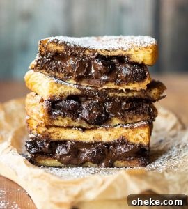 French Toast Sandwich 3 French toast sandwiches stacked on each other with chocolate spilling out