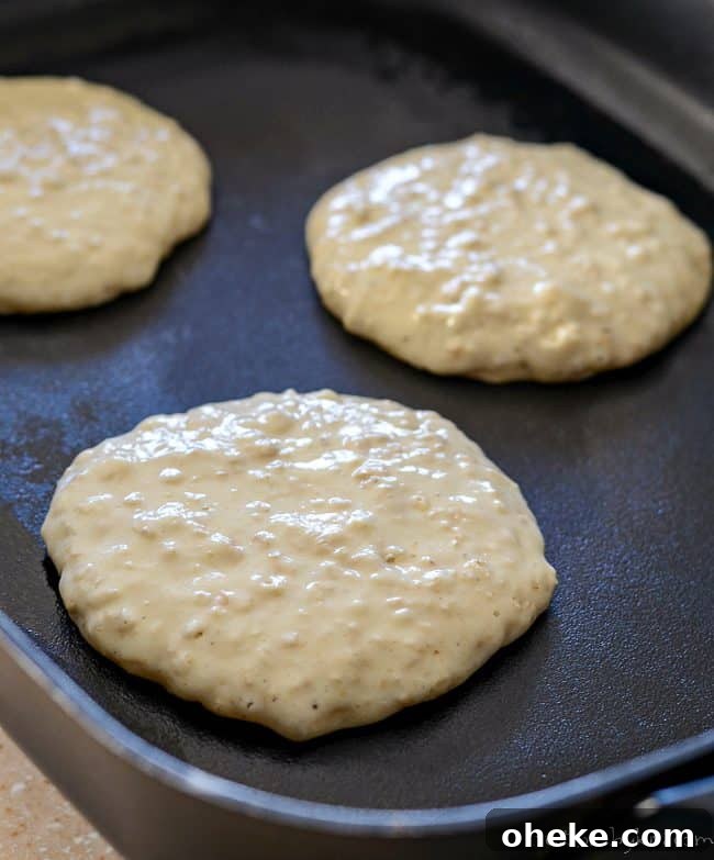 Learn how to make tasty oatmeal pancakes. These tender oatmeal pancakes with buttermilk and brown sugar are sure to become a breakfast favorite! oatmeal pancakes cooking on a skillet
