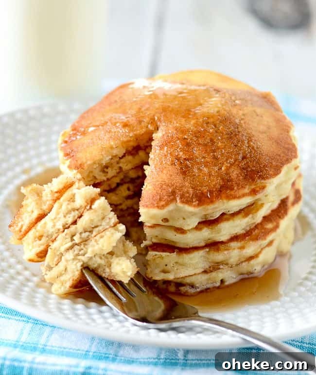 Oatmeal Pancakes Recipe - start the morning off right with these hearty and tasty oatmeal pancakes! stack of oatmeal pancakes and syrup on a plate with a fork