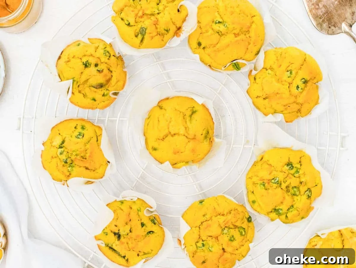 Savory Chickpea Frittata Muffins for Meal Prep 3 Chickpea Muffins on a cooling rack with peas and cauliflower