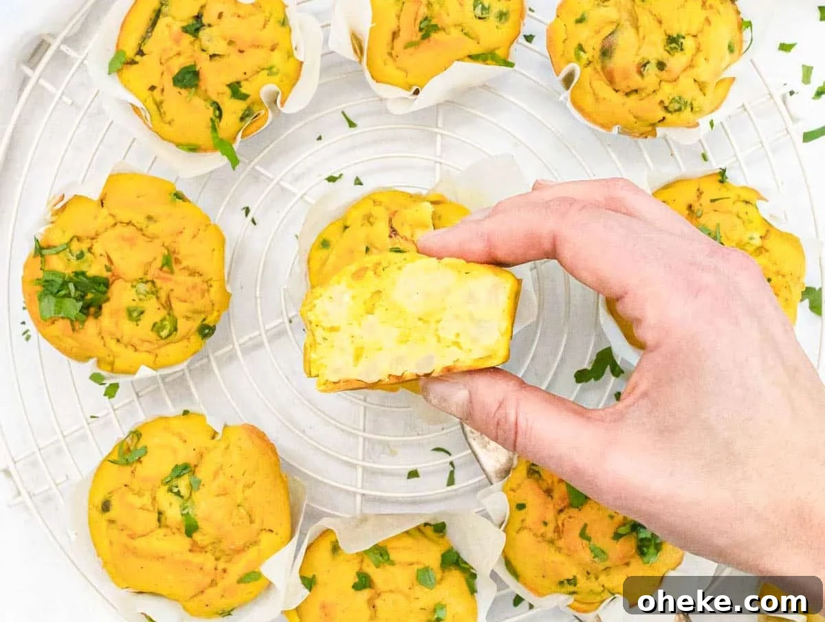 Savory Chickpea Frittata Muffins for Meal Prep 6 Chickpea Muffins cut in half with cauliflower and a hand