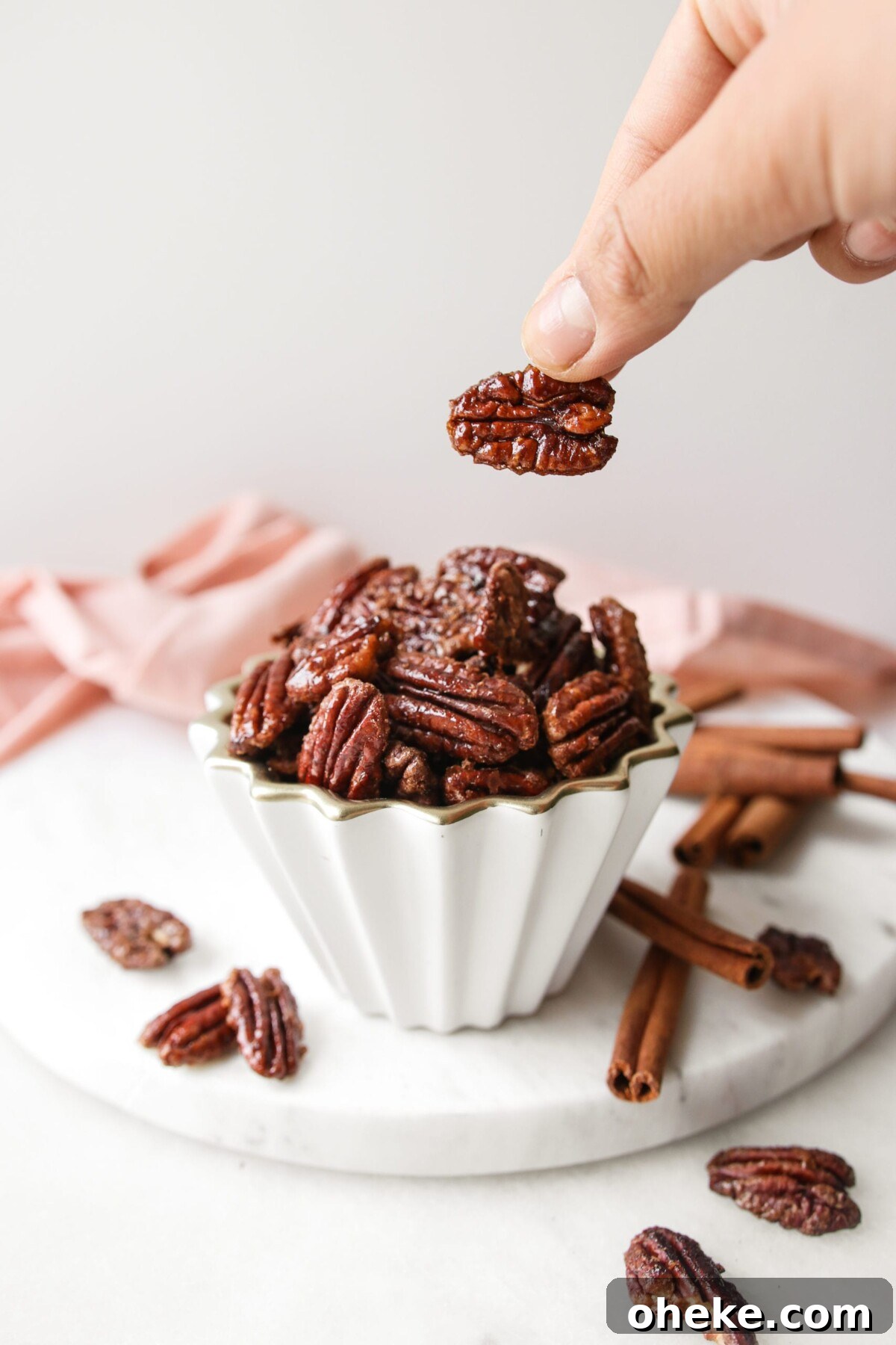Pumpkin Spice Candied Pecans (No Butter, Vegan-Friendly) 2 pumpkin spice pecans in a white bowl