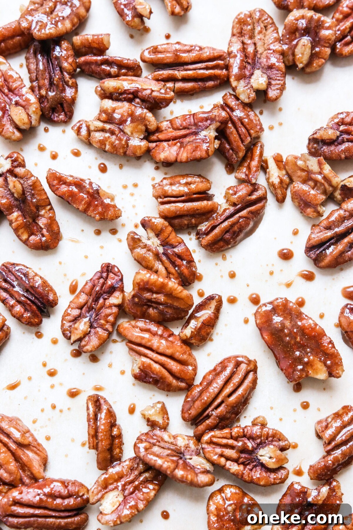 Pumpkin Spice Candied Pecans (No Butter, Vegan-Friendly) 4 finished pecans on a white surface