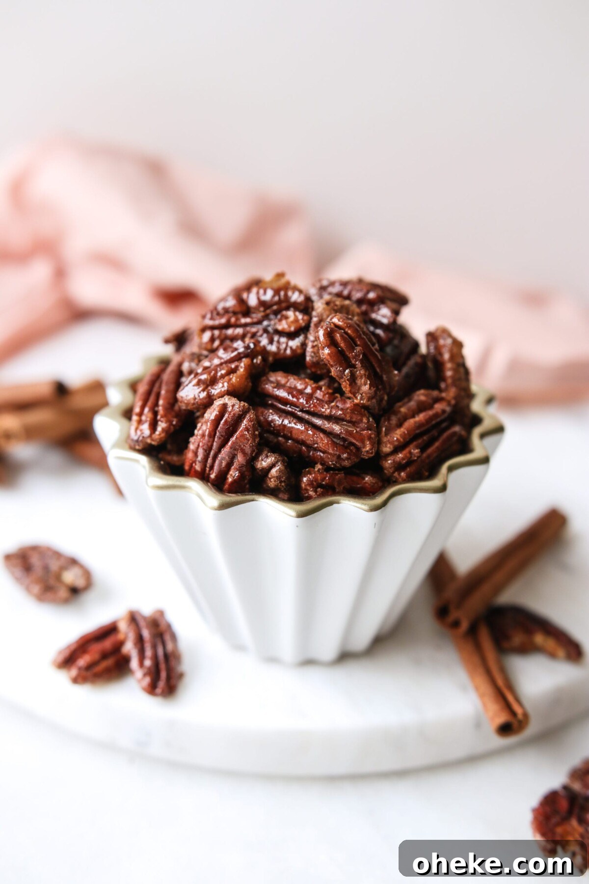 Pumpkin Spice Candied Pecans (No Butter, Vegan-Friendly) 5 a bowl of pumpkin spice pecans on a white platter