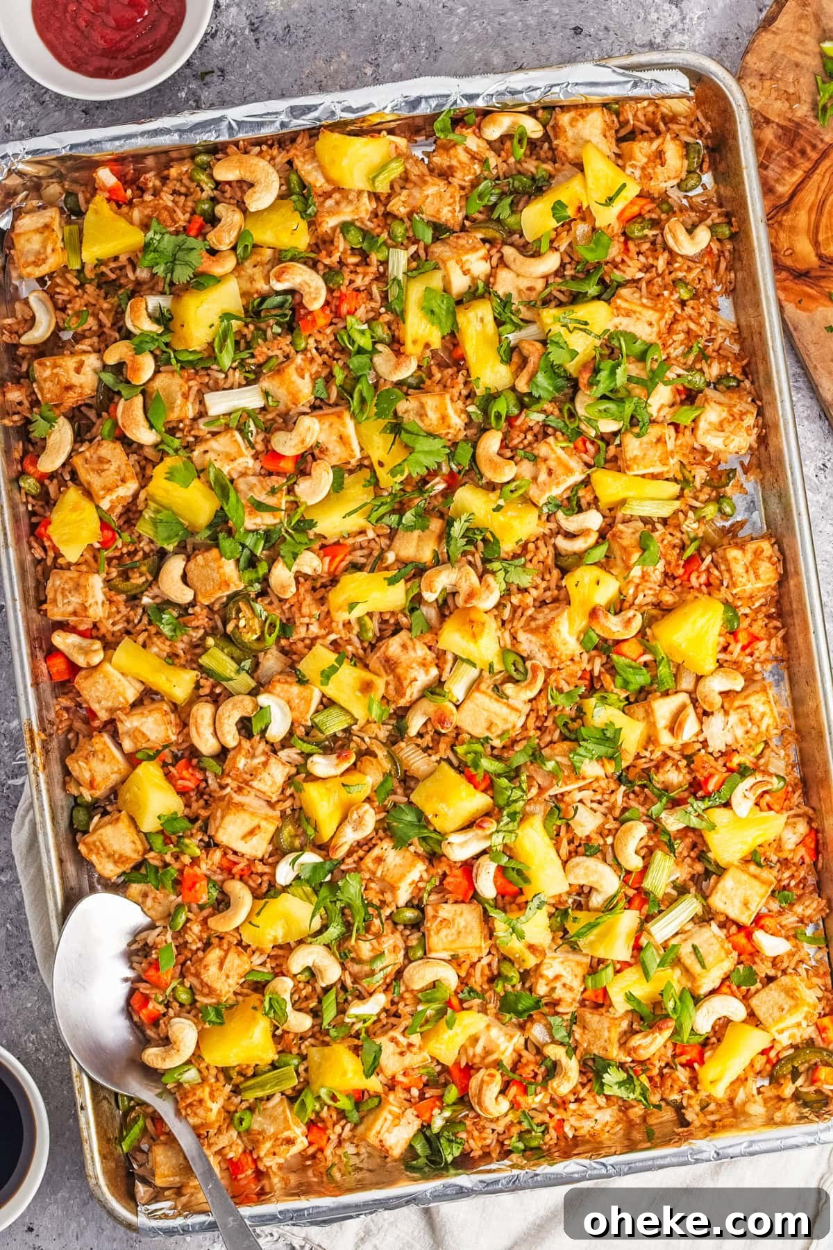 Wok-Seared Pineapple Fried Rice with Shrimp and Cashews 2 An overhead image of pineapple fried rice on a sheet pan.