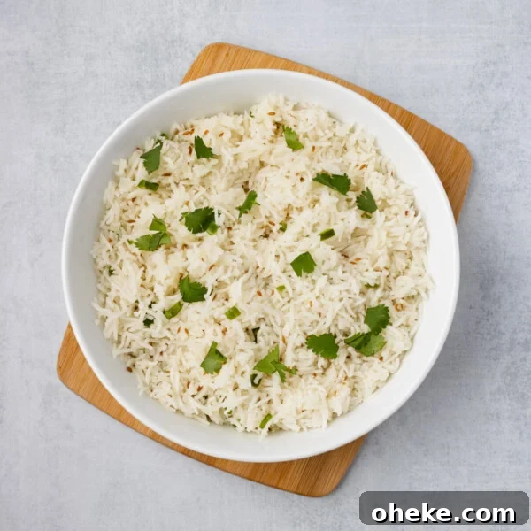 Wok-Seared Pineapple Fried Rice with Shrimp and Cashews 18 An overhead image of quick jeera rice in a serving bowl.