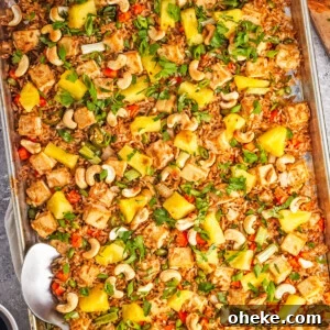 Wok-Seared Pineapple Fried Rice with Shrimp and Cashews 19 An overhead image of pineapple fried rice on a sheet pan.