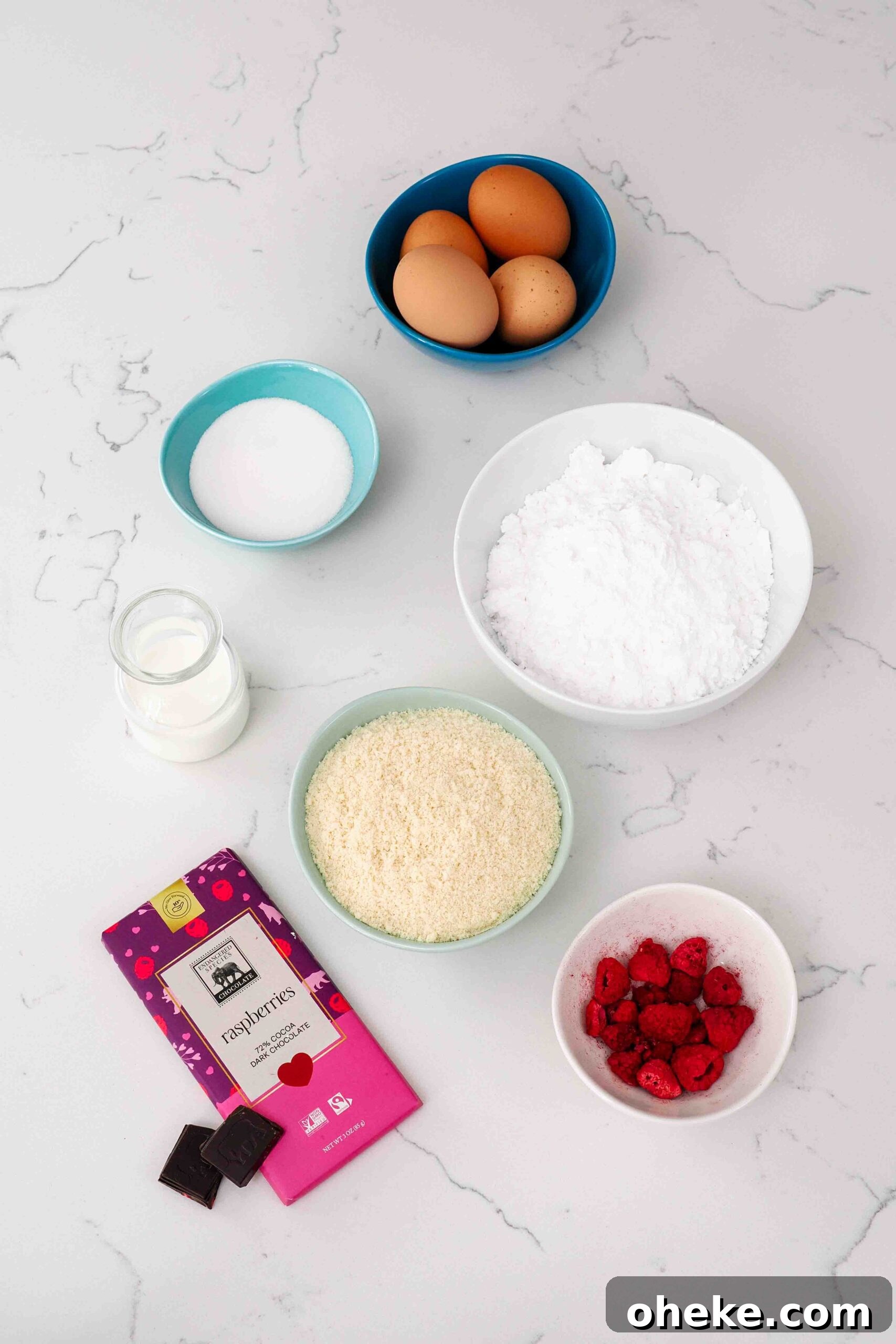 Heart-Shaped Chocolate Raspberry Macarons Recipe 2 Ingredients for chocolate raspberry macarons on a quartz countertop.