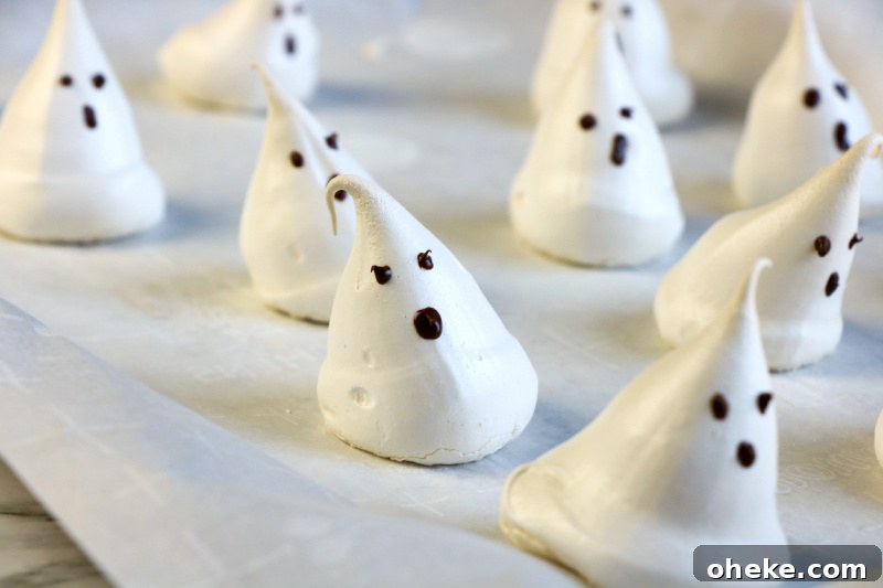 Ghost Meringues Recipe: How to Make Spooky Meringue Cookies 10 These ghost meringues are finish hardening on parchment paper on the cookie sheet.