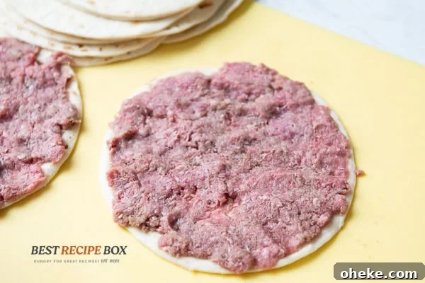 Beef flattened on top of a tortilla