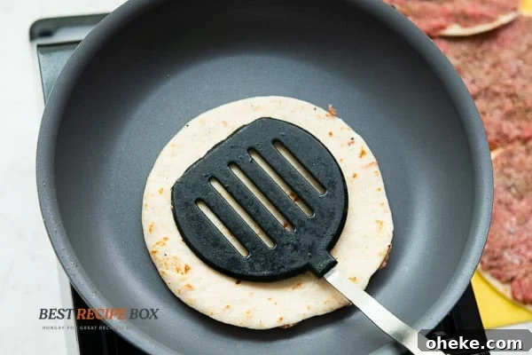 Tortilla, meat side down on pan
