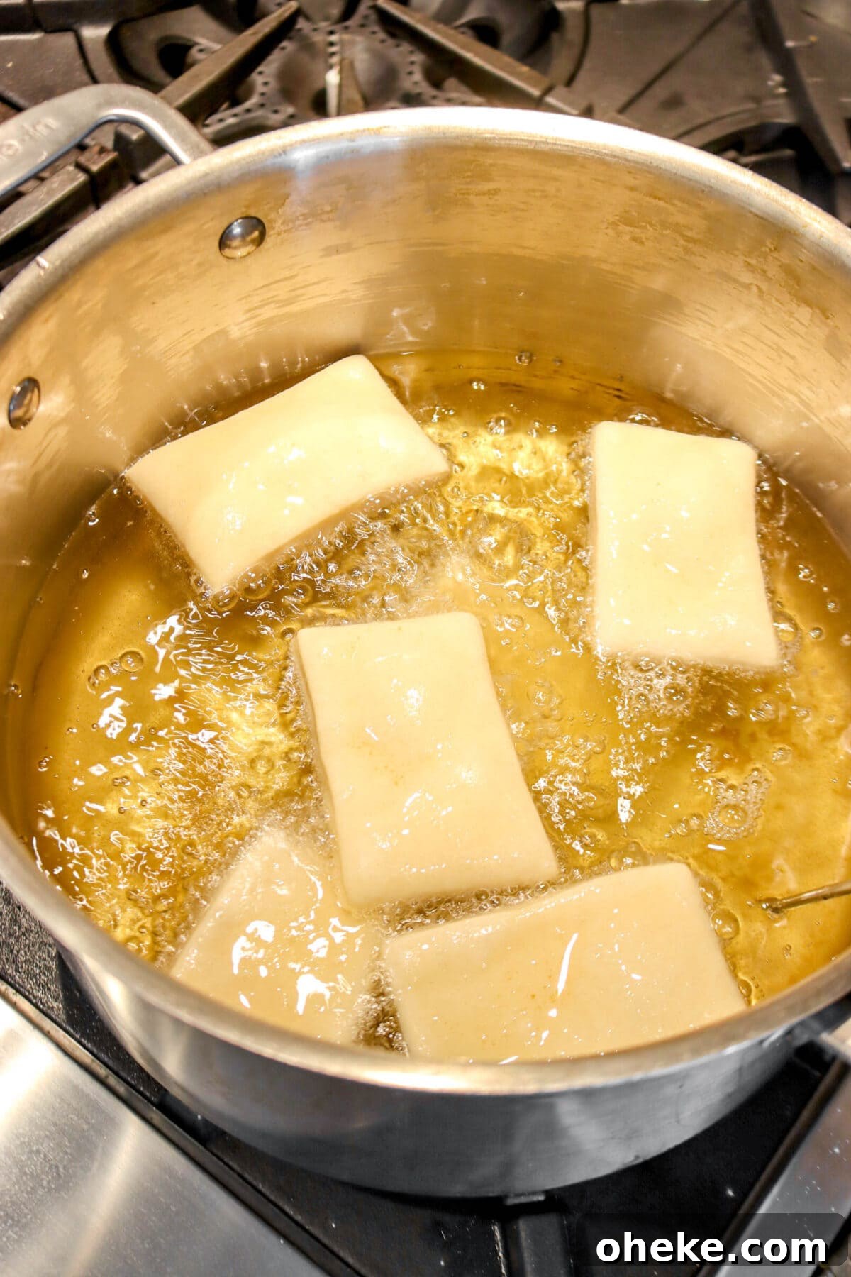 six beignets being fried