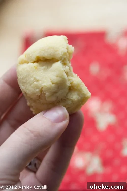 Cracked Sugar Cookies Recipe for Soft, Chewy Cookies 2 Sugar cookie with a bite taken out.