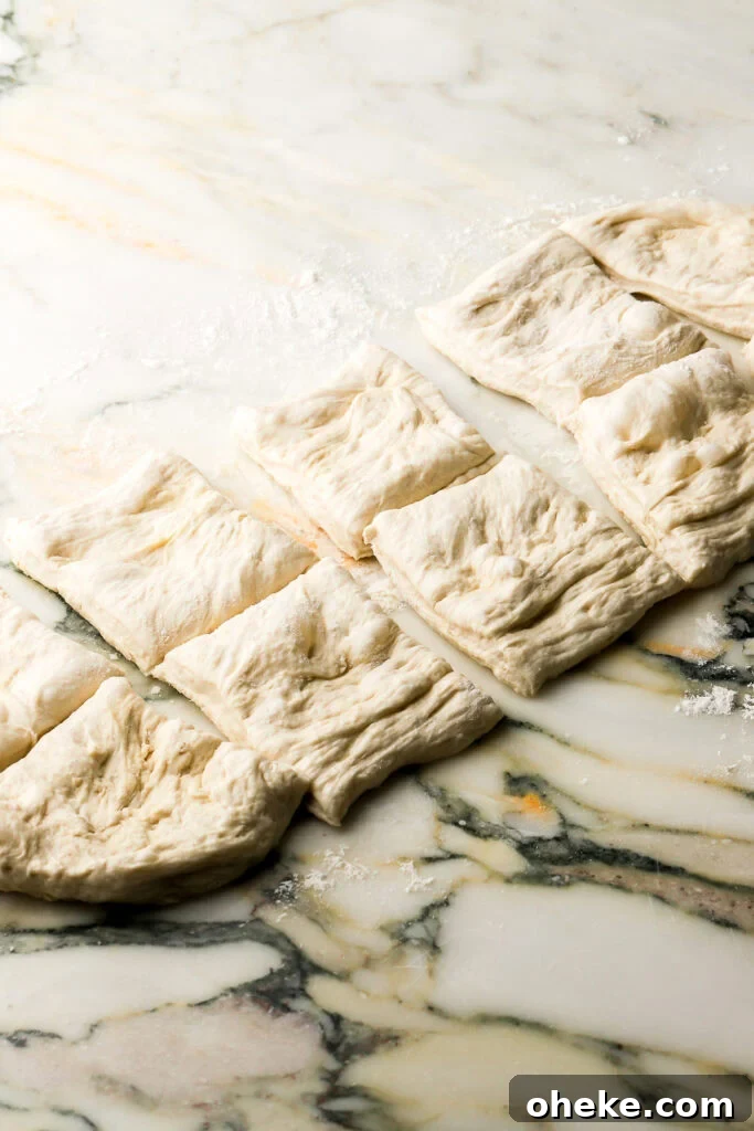 dough sliced in half and then into 10 squares