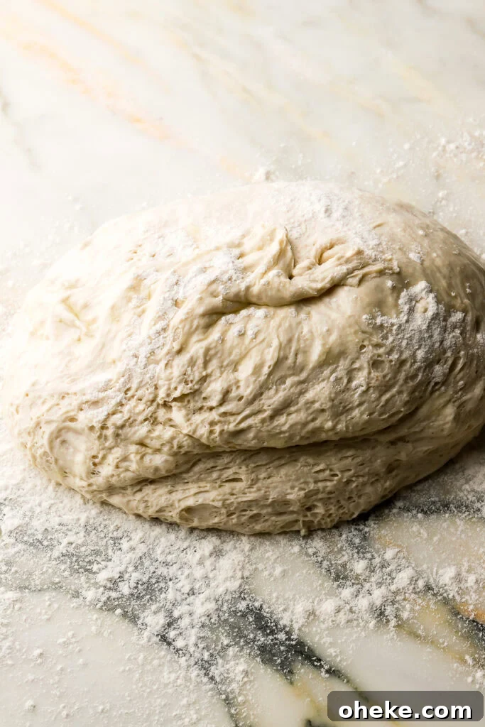 ciabatta dough flopped onto a floured surface