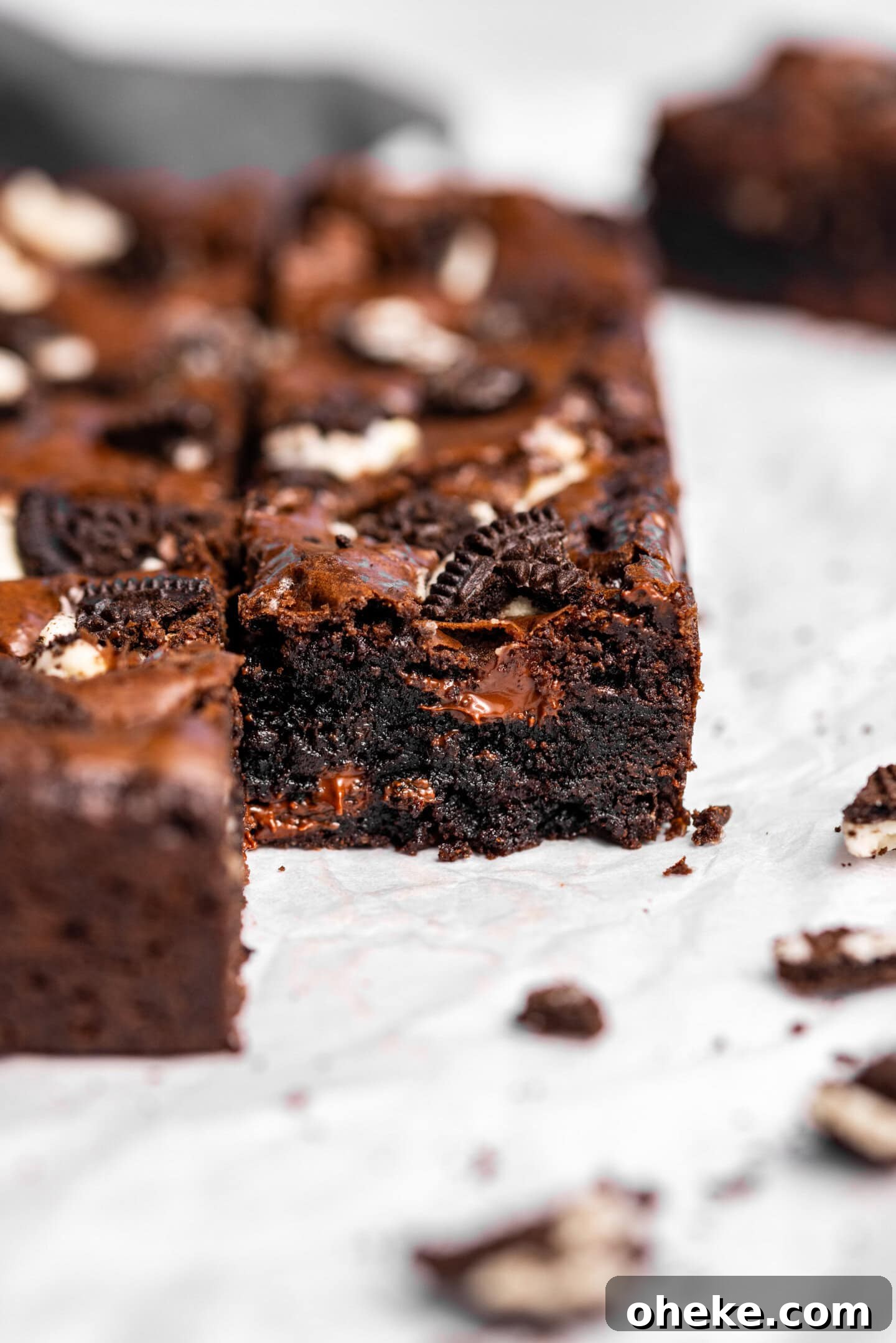 Close up of Oreo brownies showing off fudgy interior with melted chocolate chips.