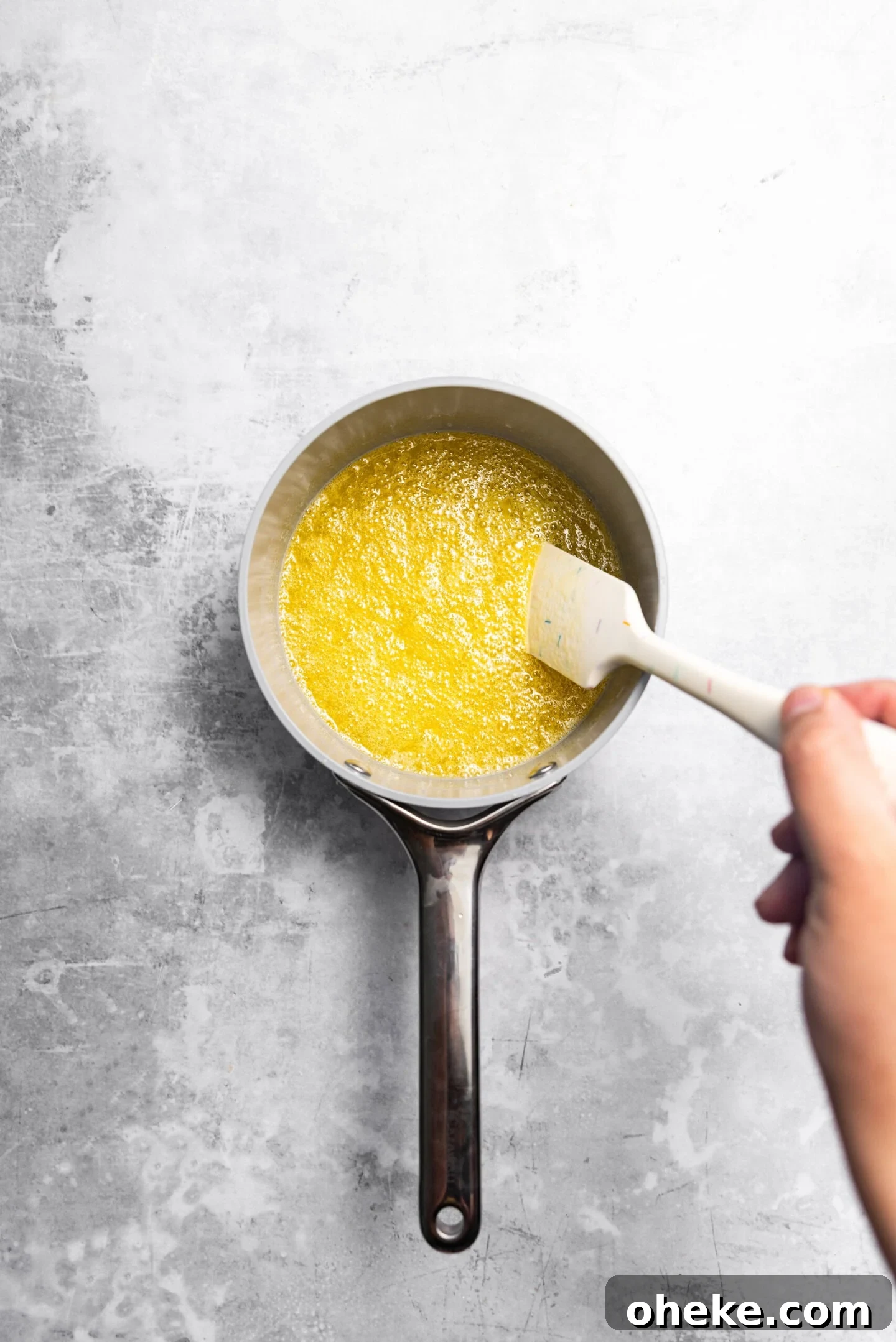 Butter, sugar, and oil being combined over medium heat until bubbly.