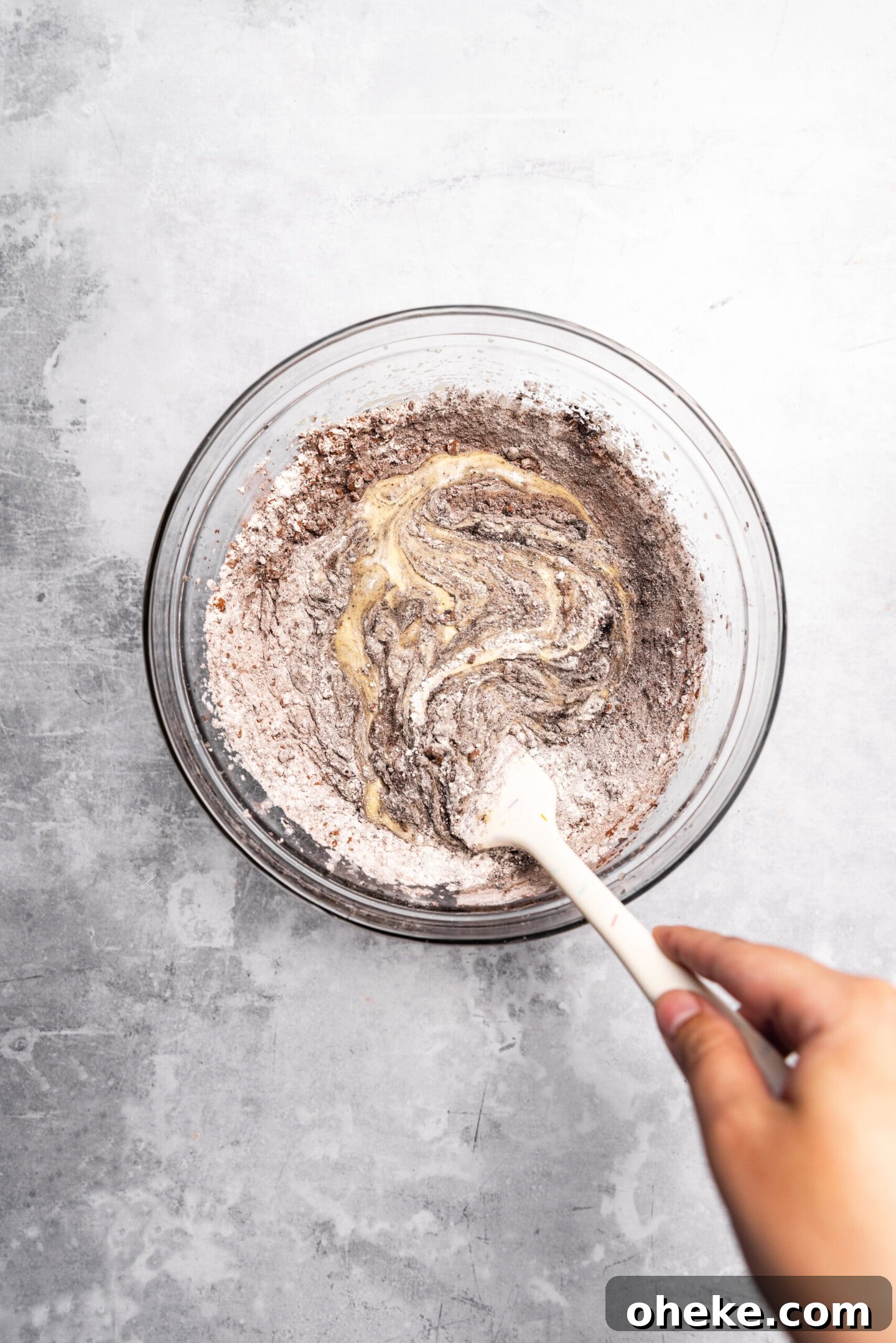 Dry ingredients being folded into brownie batter.