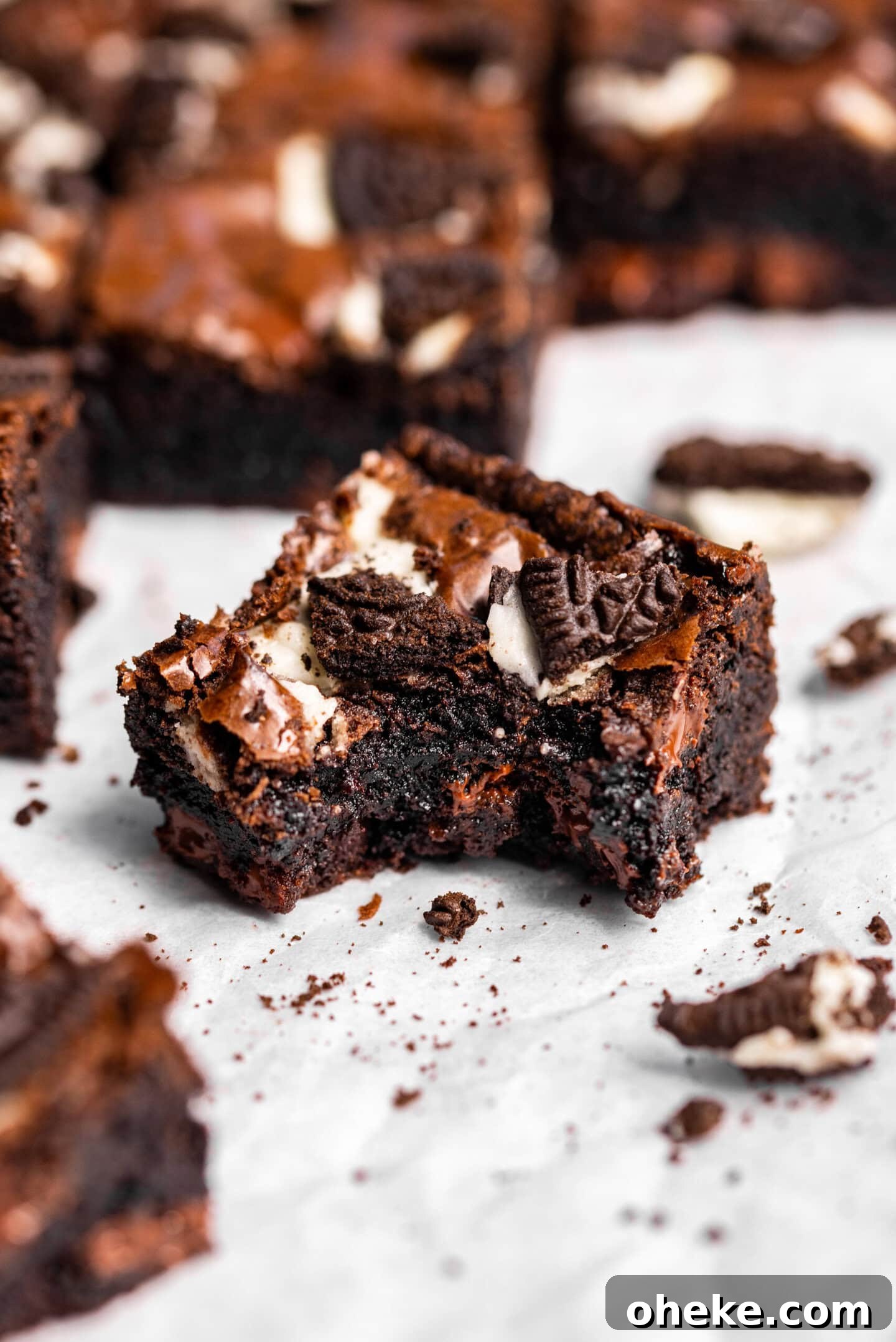 Close up of oreo brownie with a bite missing showing off moist and fudgy texture.