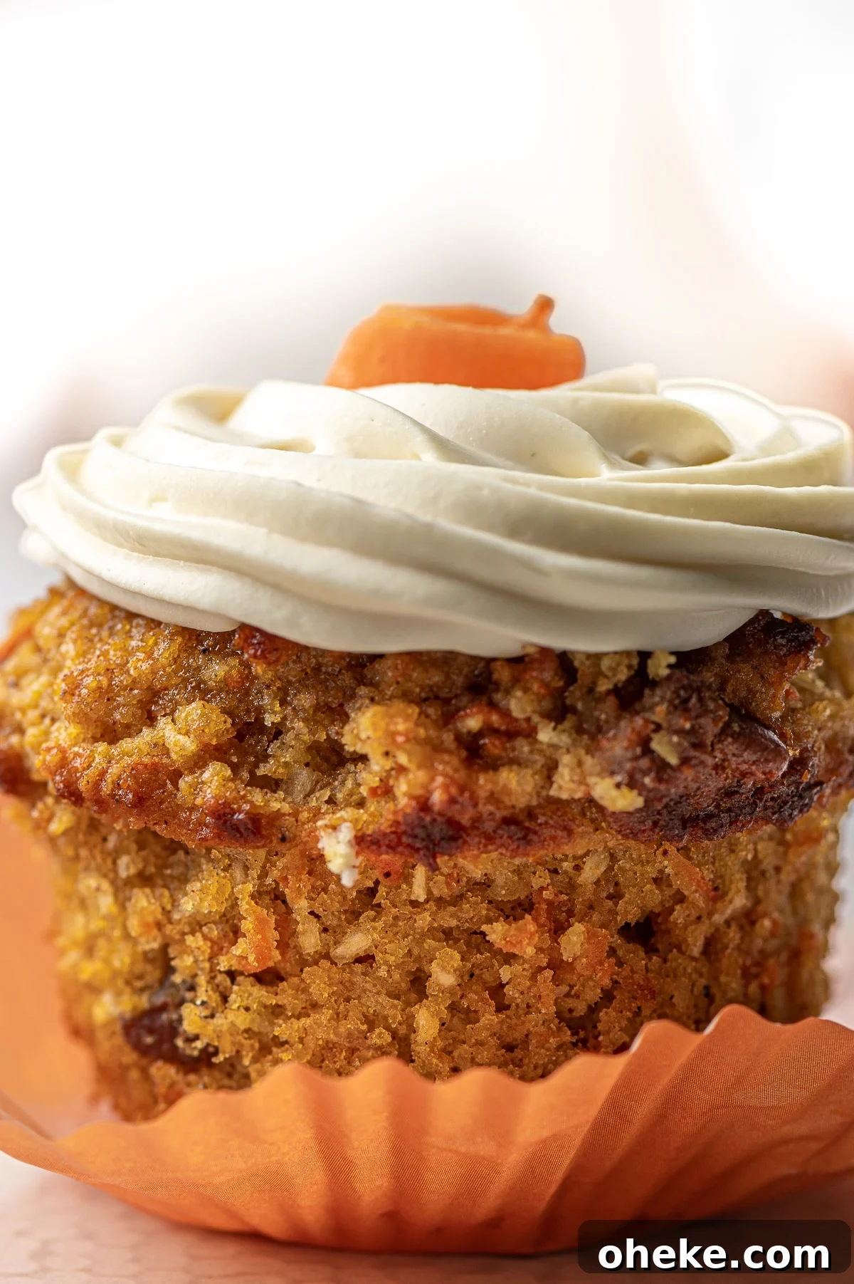 A close up image of a muffin with the wrapper pulled down.  