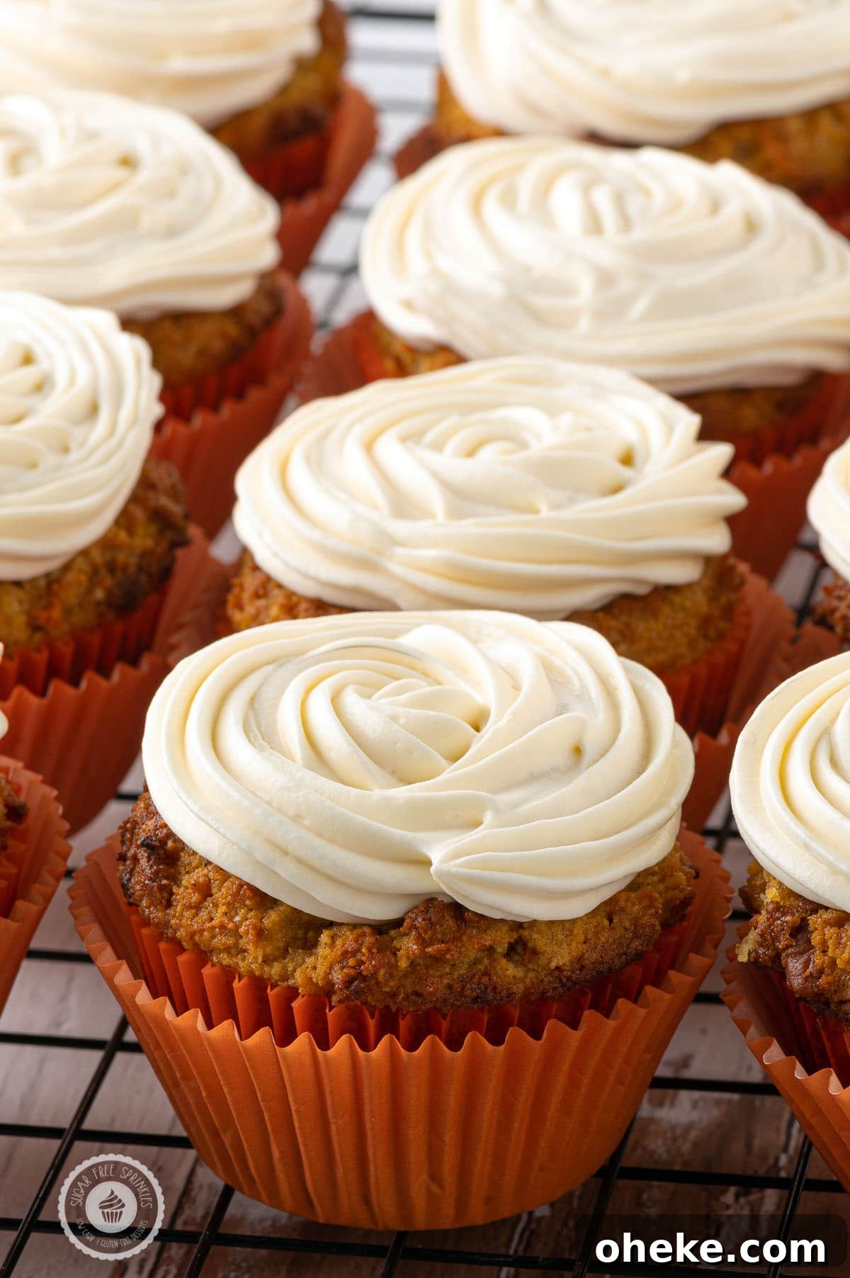 Stacks of freshly baked muffins with perfect swirls of cream cheese frosting 