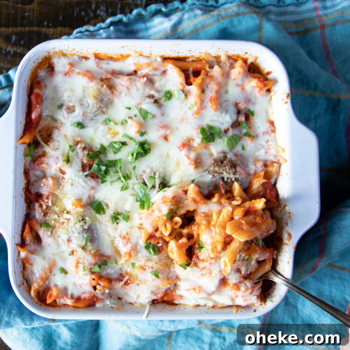September Week 2 Vegetarian Meal Plan: Fresh Recipes & Grocery List 4 Meatball casserole with pasta in a baking dish with a spoon dishing up.