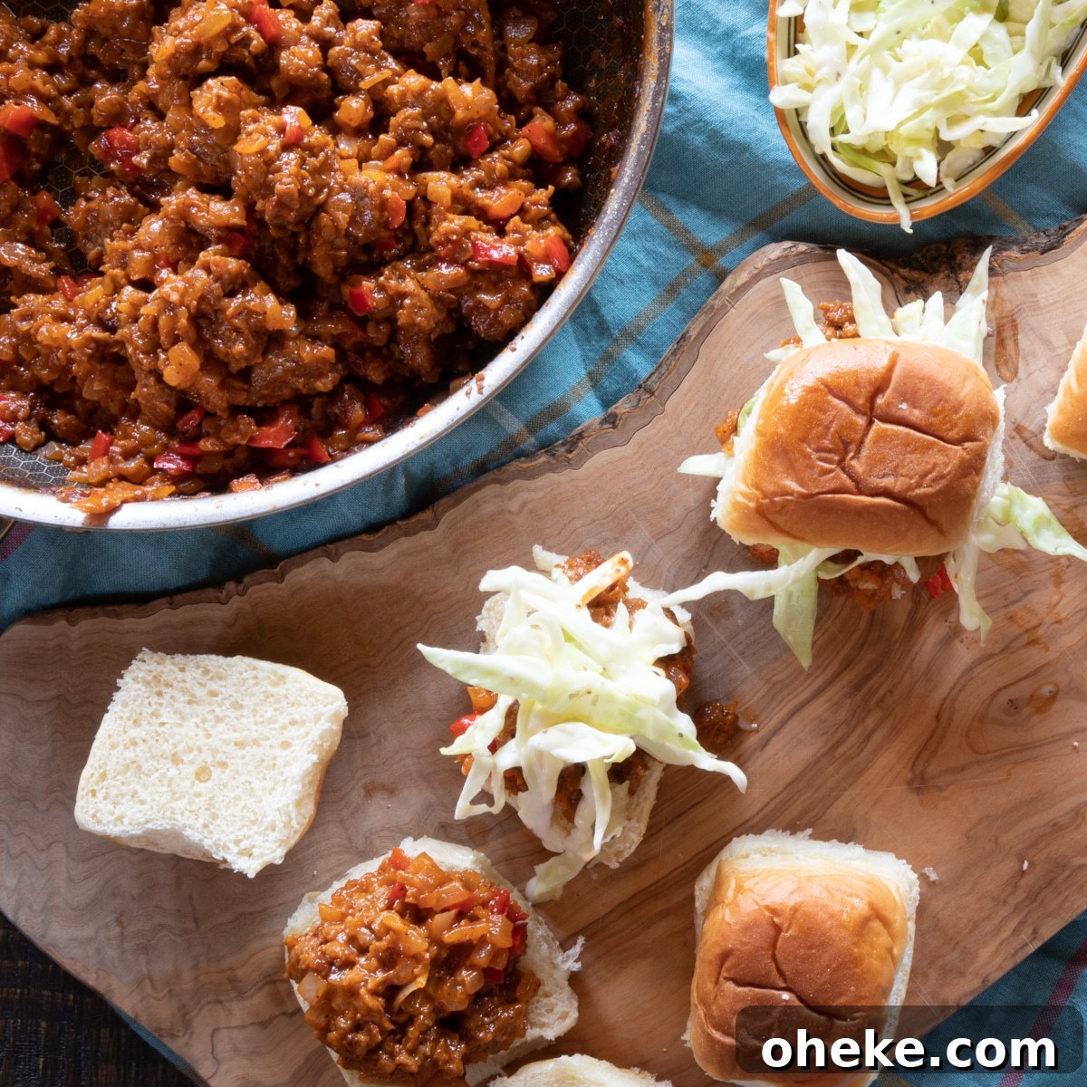September Week 2 Vegetarian Meal Plan: Fresh Recipes & Grocery List 8 A skillet of sloppy joes, a dish of coleslaw, and a few sliders being made.