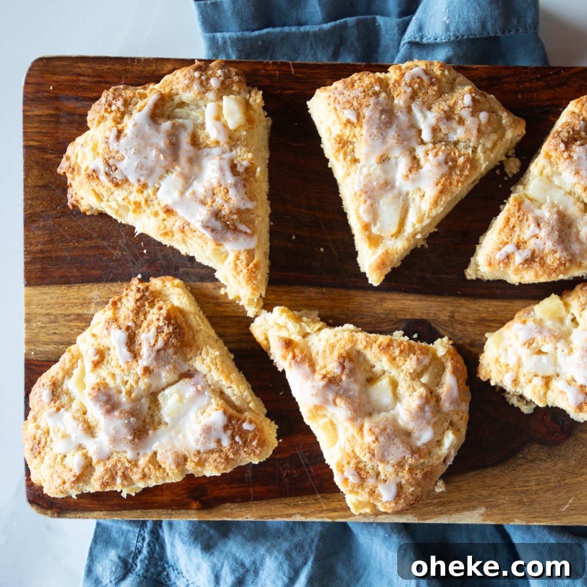 September Week 2 Vegetarian Meal Plan: Fresh Recipes & Grocery List 10 Glazed peach scones on a cutting board and a blue napkin.