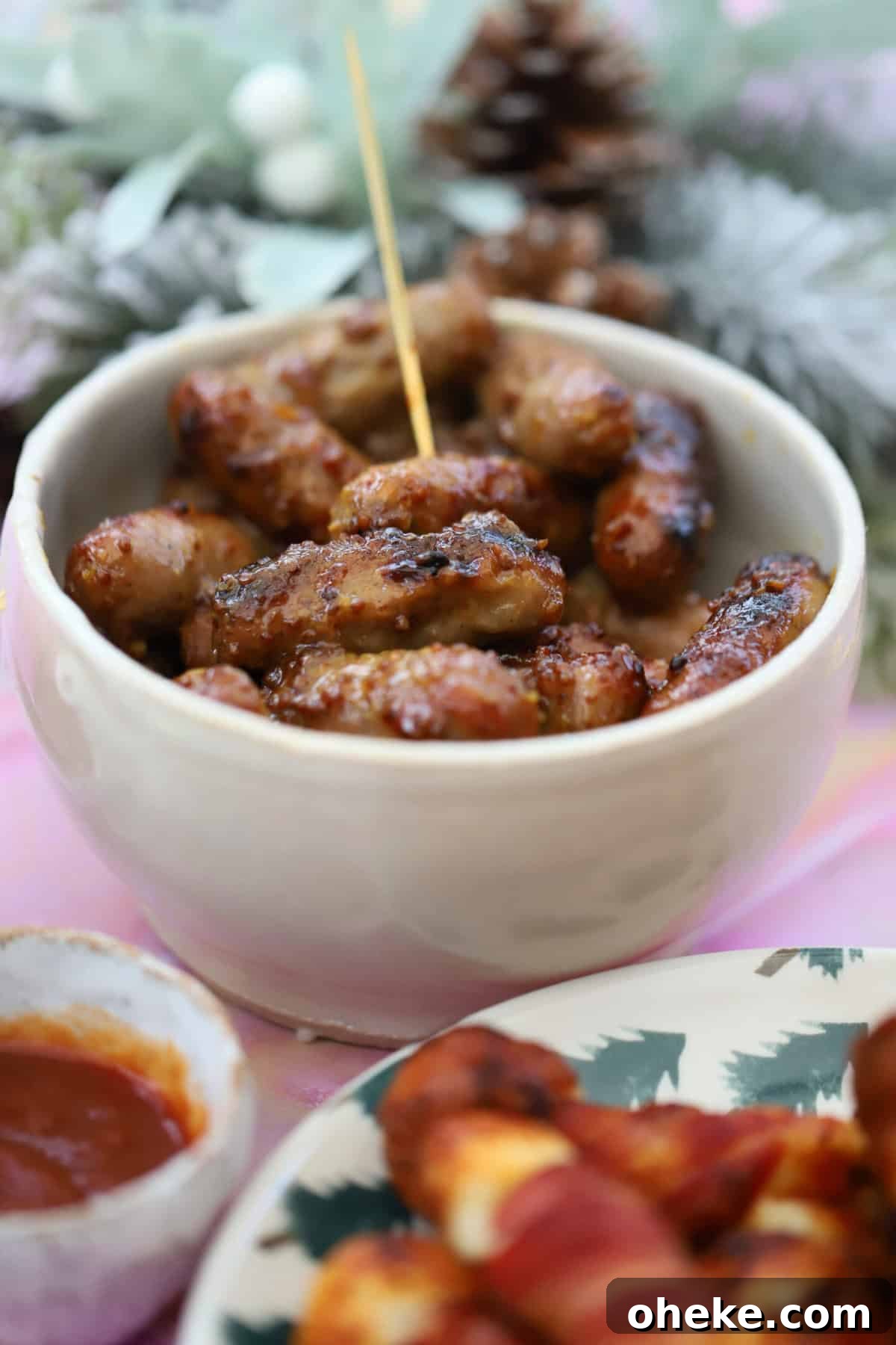 Honey Mustard Cocktail Sausages Recipe for Parties 4 A bowl of honey and mustard cocktail sausages with a festive backdrop.
