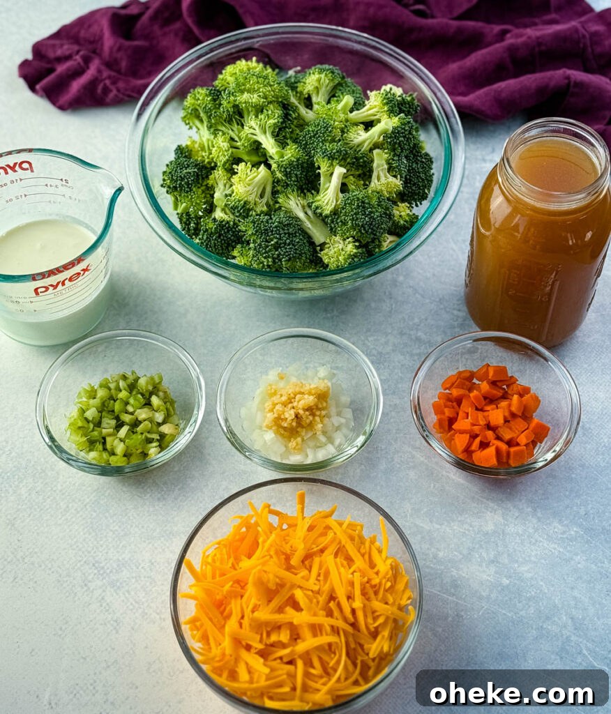 Slow Cooker Broccoli Cheddar Soup (Crockpot Recipe) 3 Glass bowls filled with ingredients for broccoli cheddar soup including fresh broccoli florets, shredded cheddar cheese, diced carrots, celery, onions with garlic, a measuring cup of cream, and a jar of broth.