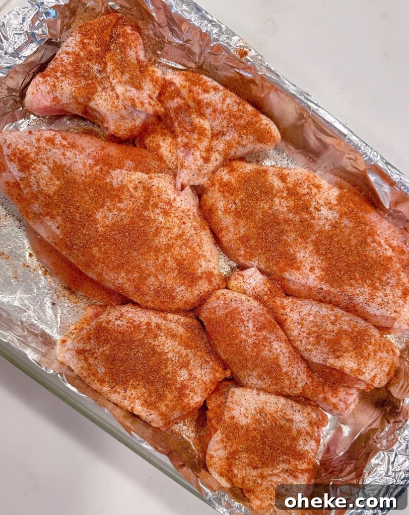 Cherry Dr Pepper Glazed Grilled Chicken Recipe 6 Chicken in foil lined baking pan and seasoned with seasonings.