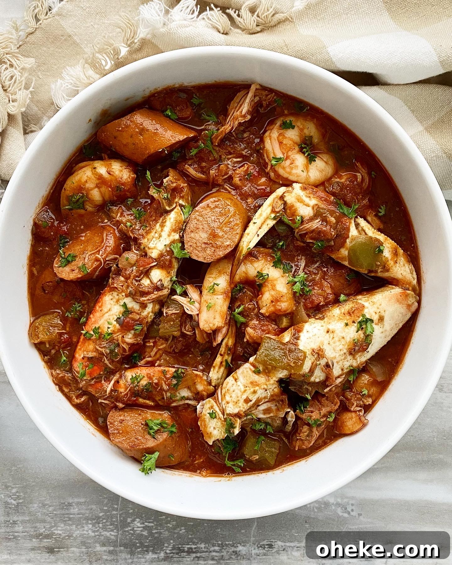 Slow Cooker Chicken and Sausage Gumbo (Video Recipe) 2 overhead shot of slow cooker gumbo in a white bowl