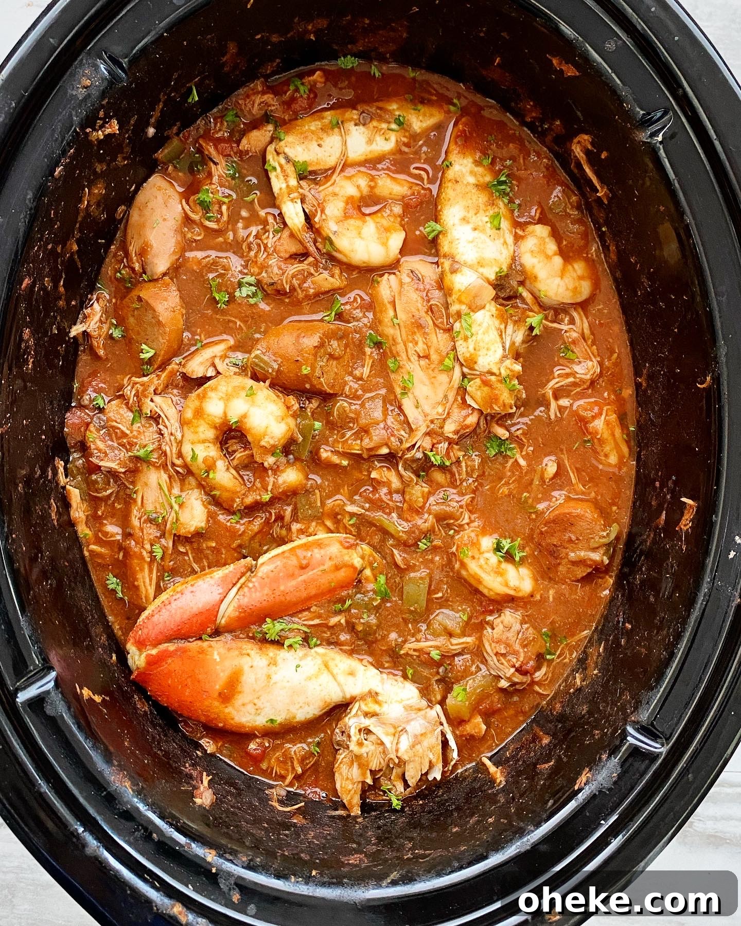 Slow Cooker Chicken and Sausage Gumbo (Video Recipe) 5 cooked gumbo in crockpot with seafood added