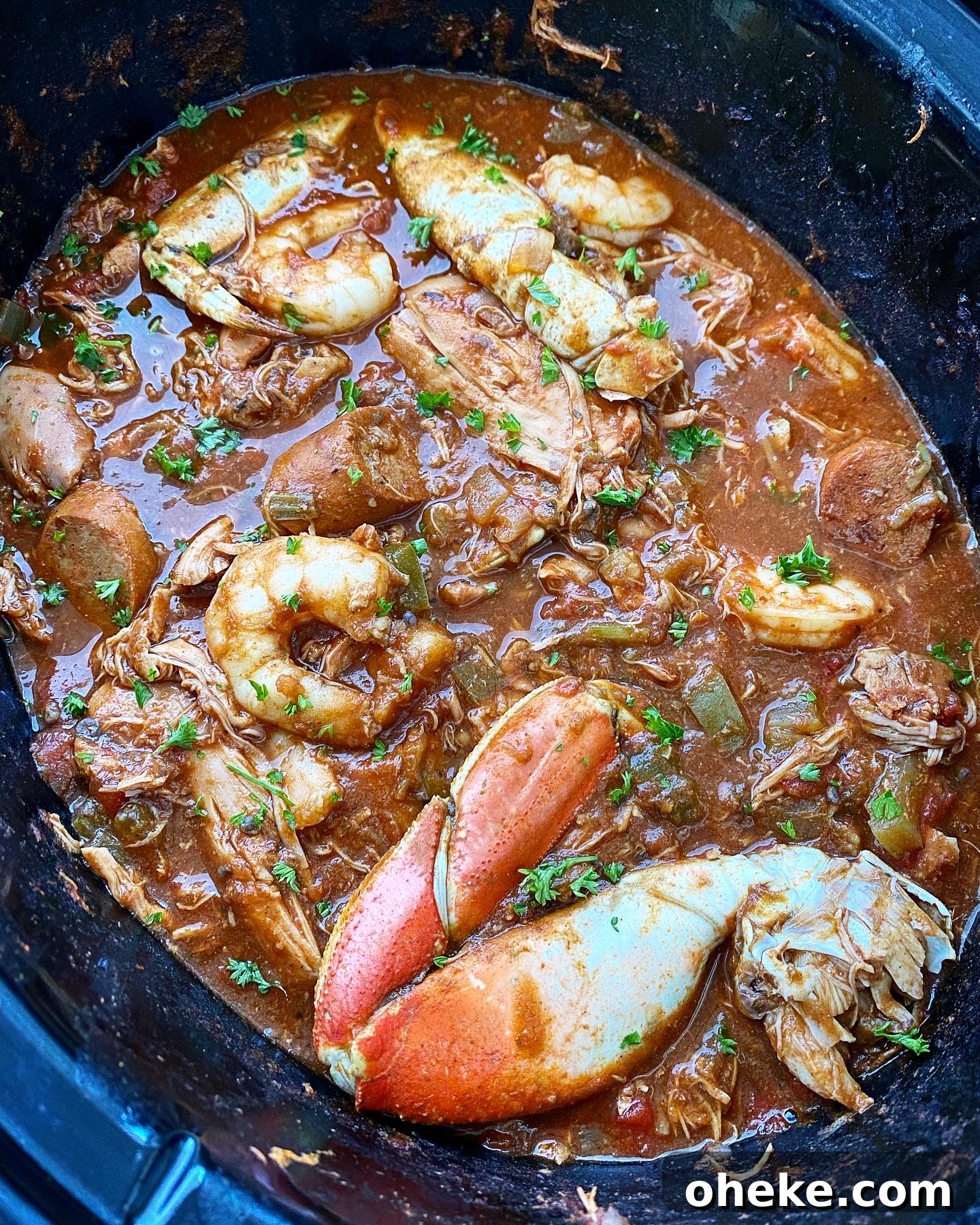 Slow Cooker Chicken and Sausage Gumbo (Video Recipe) 6 close up side view of cooked gumbo in the crockpot