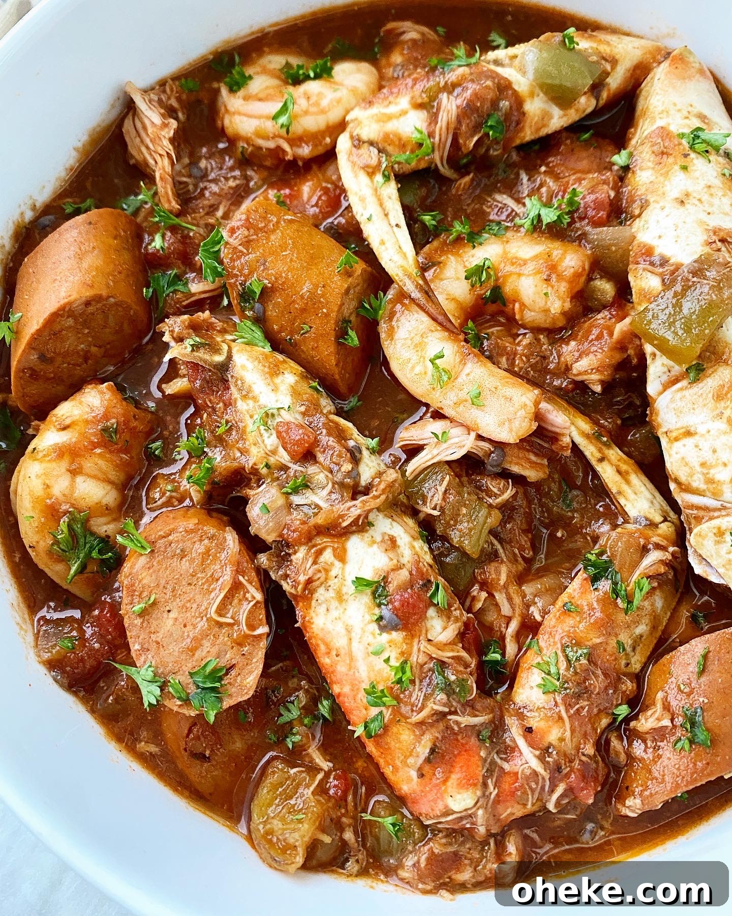 Slow Cooker Chicken and Sausage Gumbo (Video Recipe) 7 close up of cooked gumbo in a white bowl