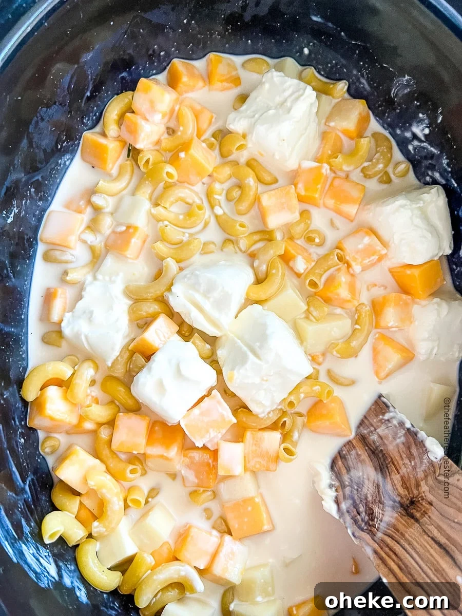 Creamy Slow Cooker Macaroni and Cheese Recipe 6 making mac and cheese with cream cheese in a slow cooker