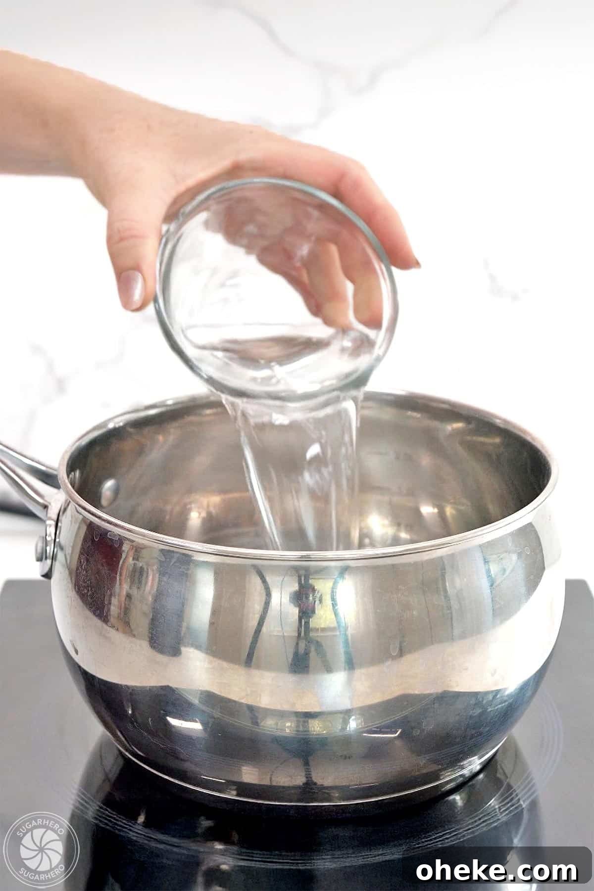 Bloody Glass Cupcakes Recipe: Spooky Jello-Filled Treats for Halloween 13 Hand pouring water into a pot.