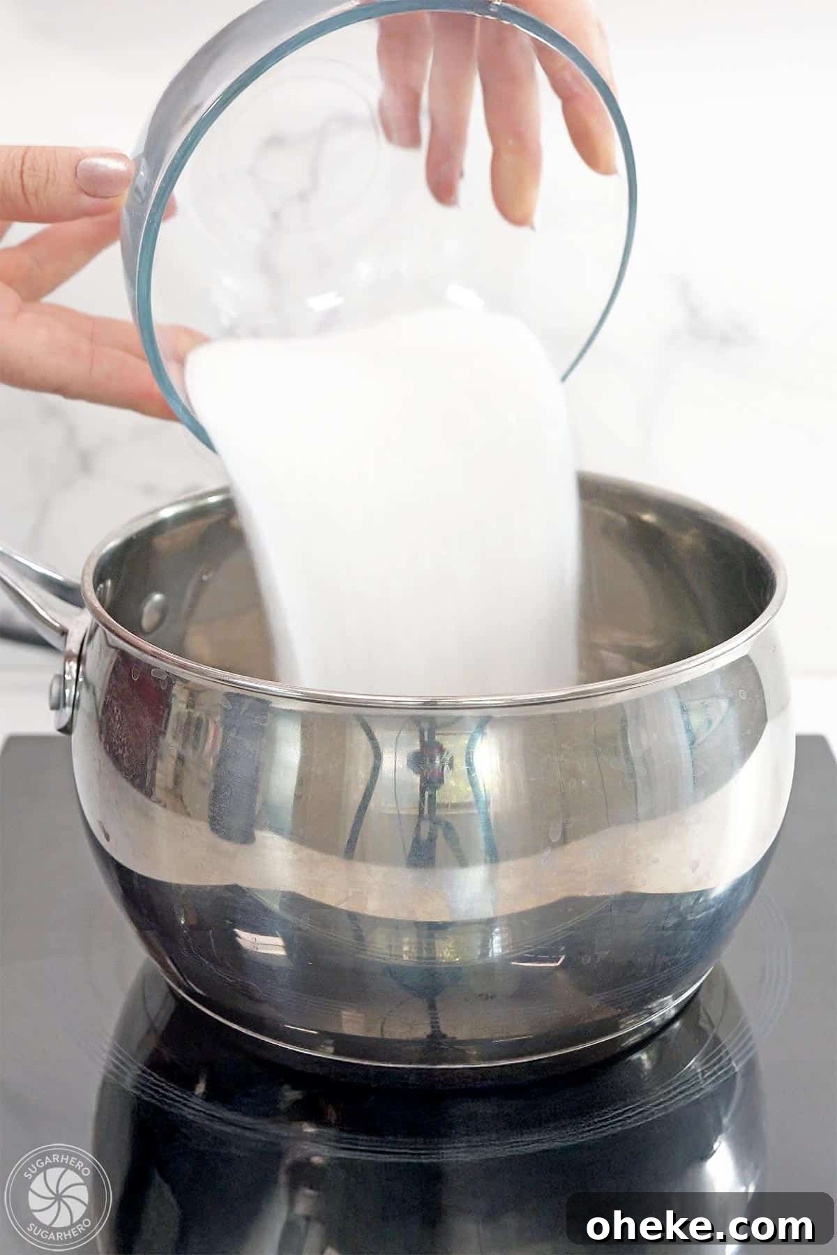 Bloody Glass Cupcakes Recipe: Spooky Jello-Filled Treats for Halloween 14 Hand pouring sugar into a pot.