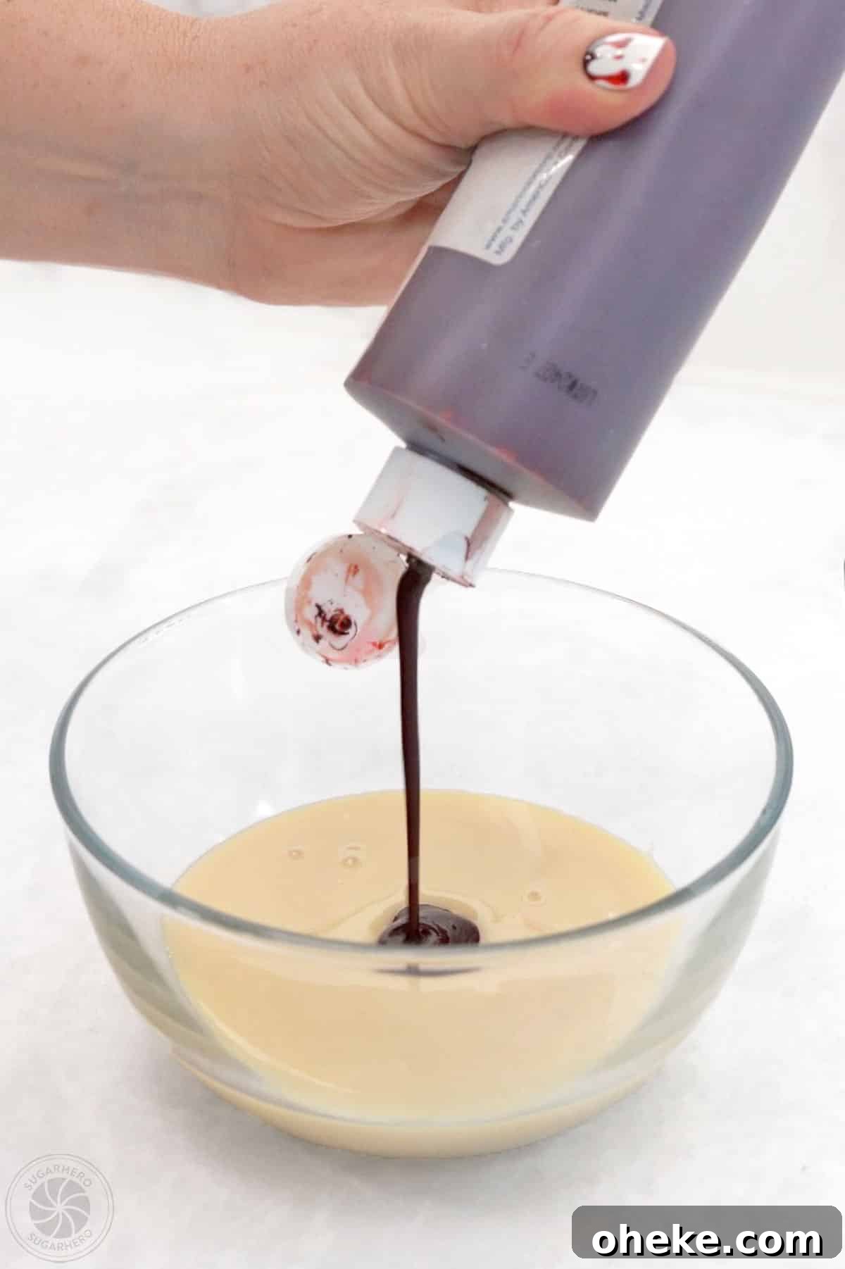Bloody Glass Cupcakes Recipe: Spooky Jello-Filled Treats for Halloween 21 Adding red food coloring to a bowl of sweetened condensed milk.